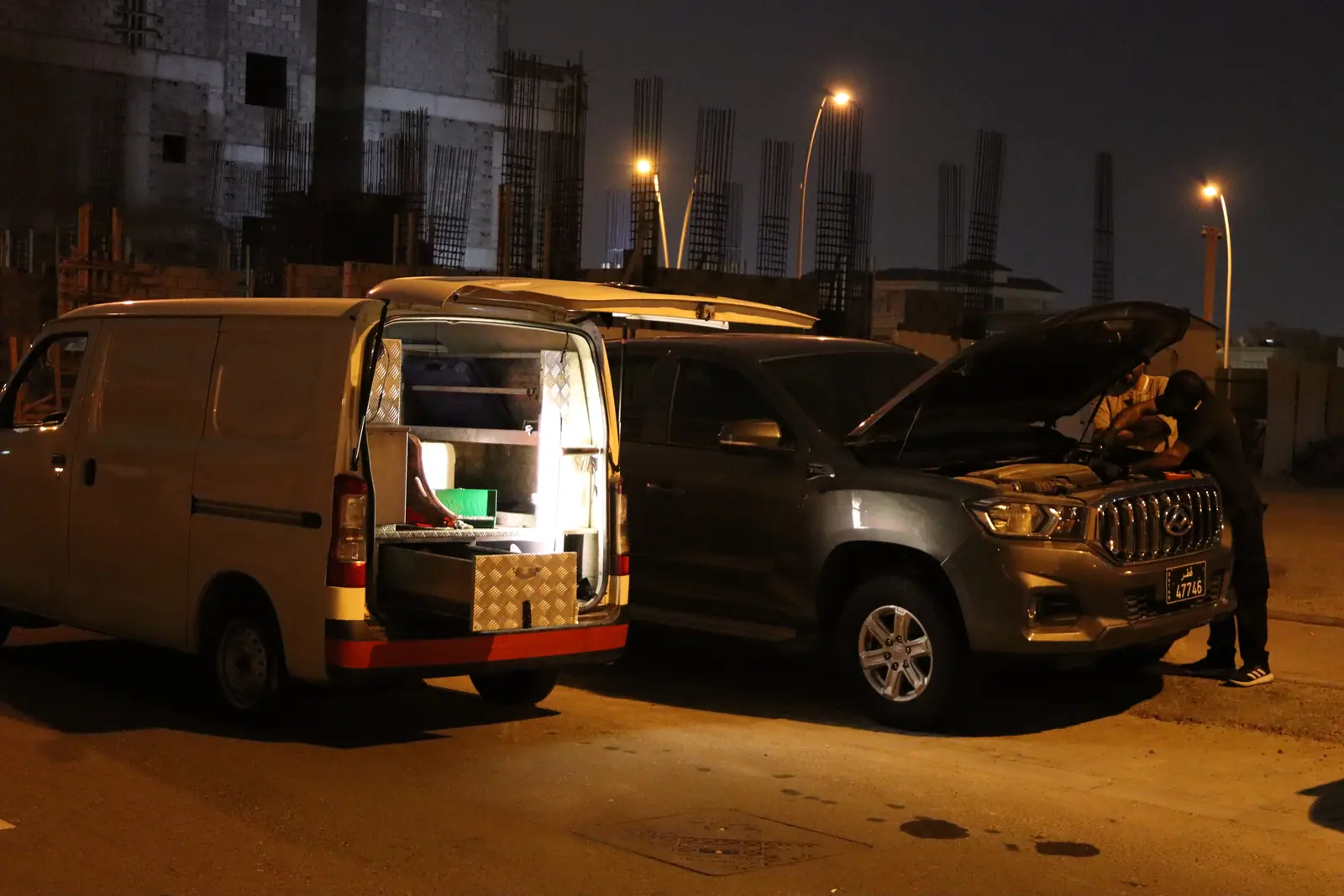 Saaed Service van and technician working on a car at night in Qatar